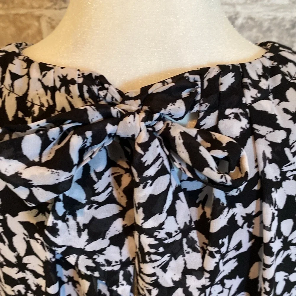 Karin Steven’s sleeveless black/white patterned lined dress. Tie at neck & waist